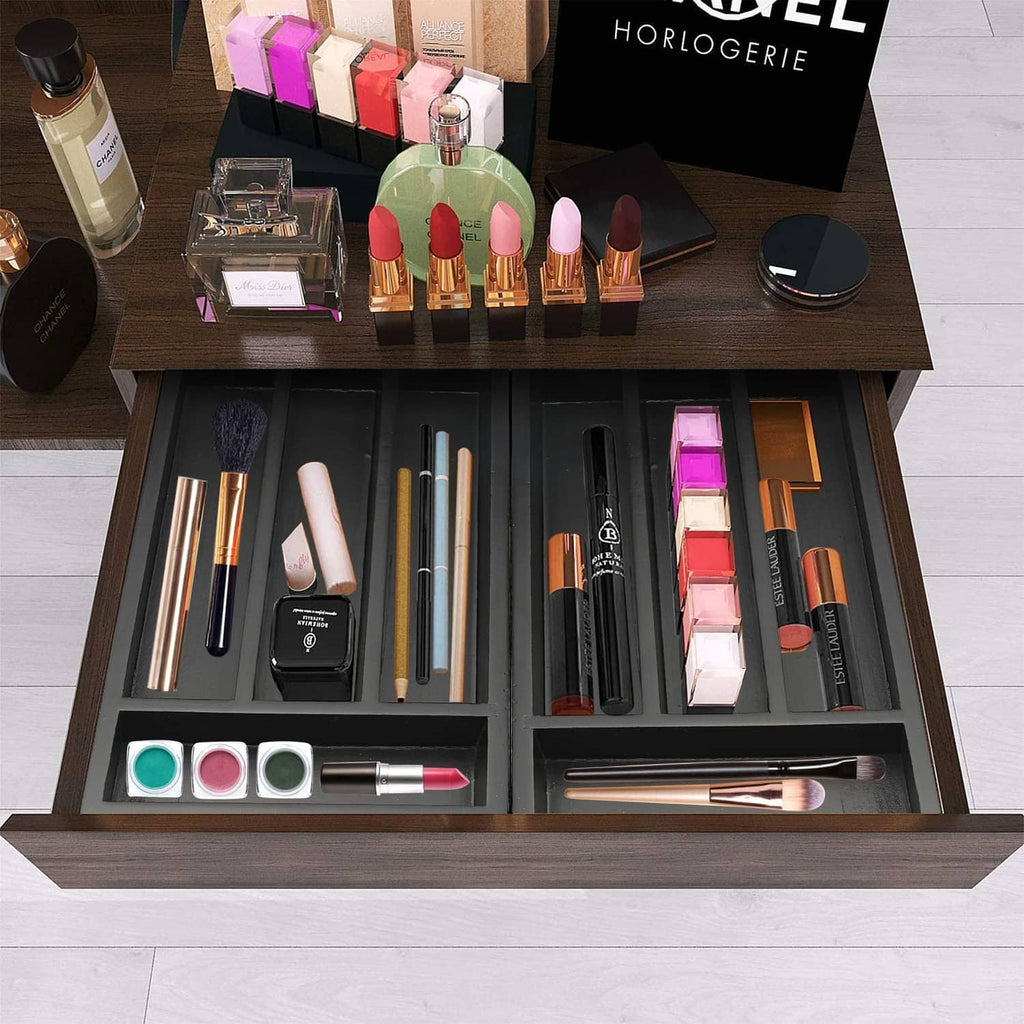 Black drawer organizer tray with separated compartments for cosmetics and tools