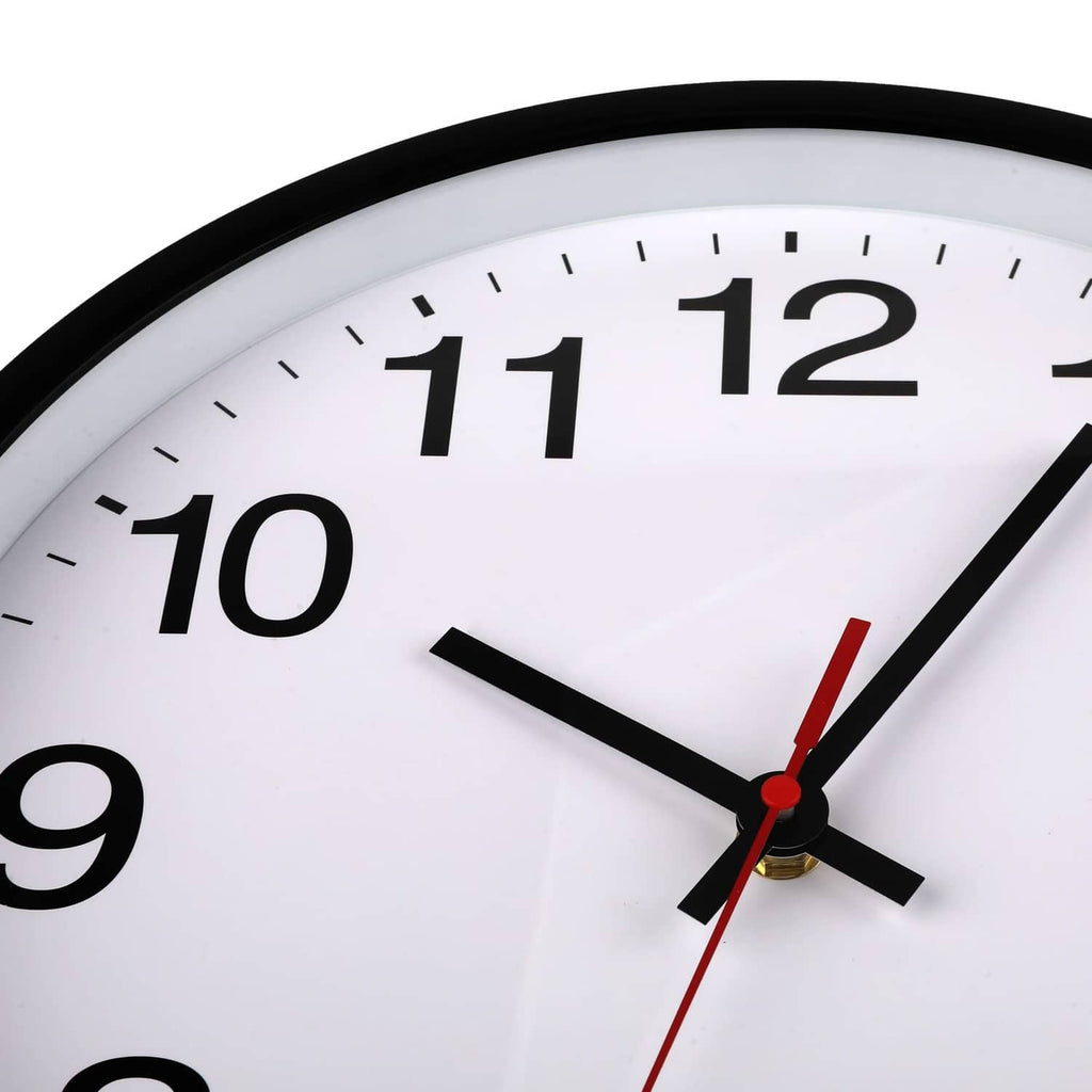 Close-up of round wall clock face with black hands and red second hand on white dial.