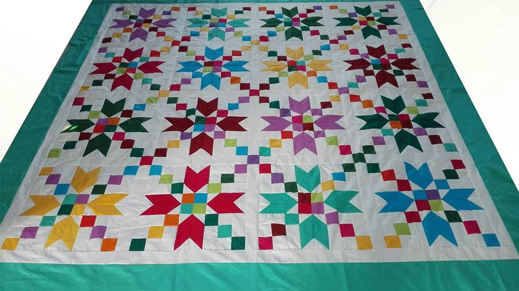 Quilt-style patchwork design with multicolor fabric squares and a turquoise border