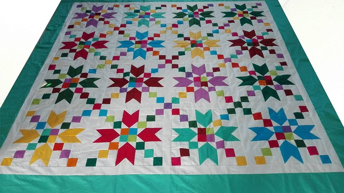 Quilt-style patchwork design with multicolor fabric squares and a turquoise border
