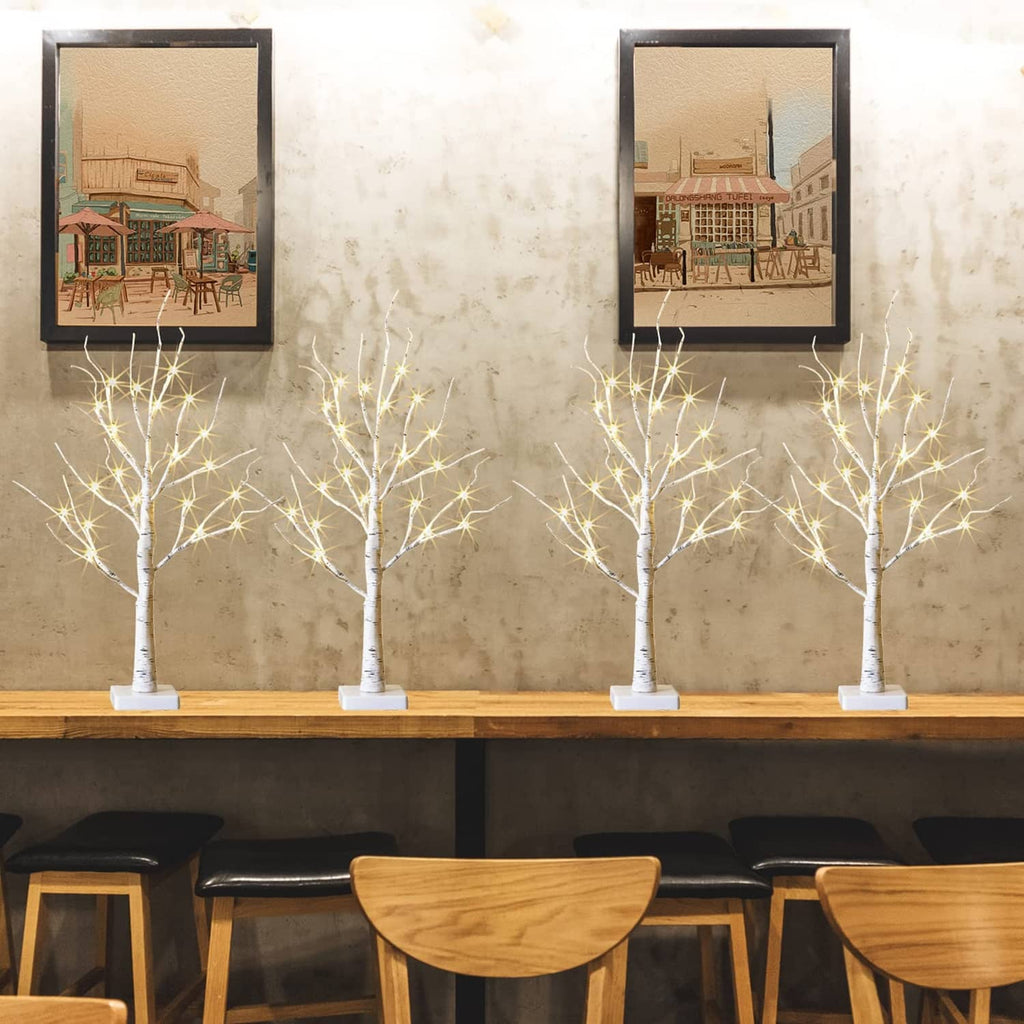 Lighted birch tree set of 4 with white trunks and warm string lights on bases