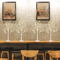 Lighted birch tree set of 4 with white trunks and warm string lights on bases