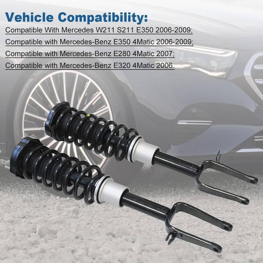 Front shock strut pair with black coil springs, silver spacers, and mounting fork brackets
