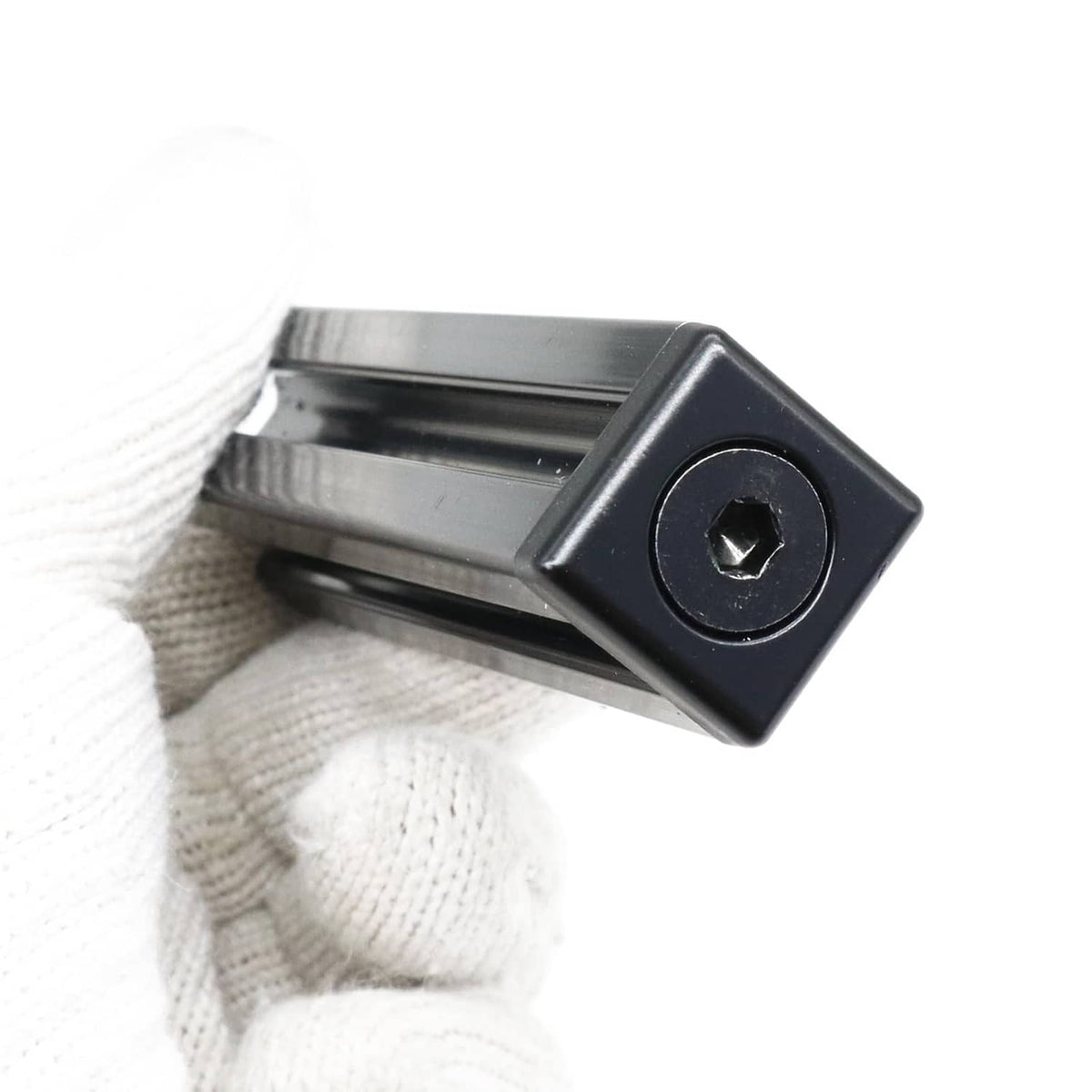 Black T-slot end cap bracket installed on aluminum extrusion channel