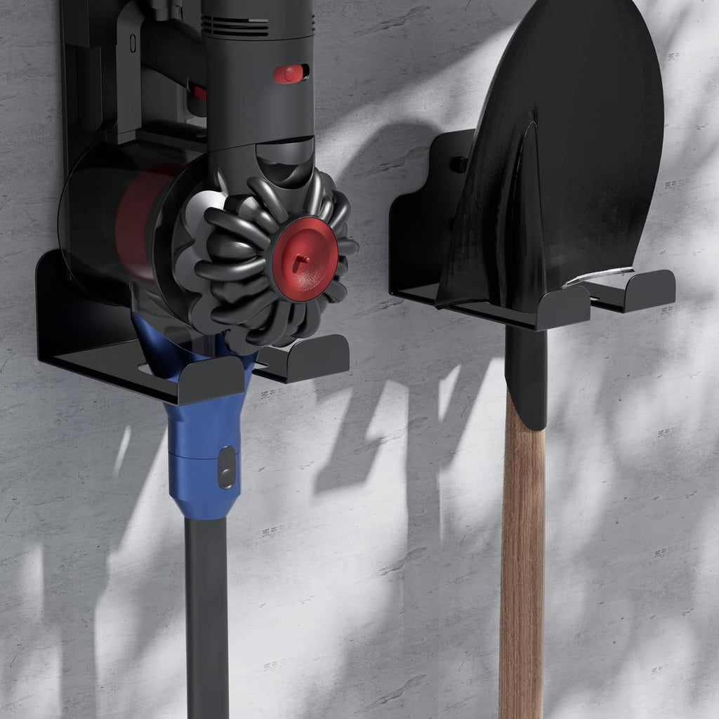 Black mounting bracket holding a power trimmer on a wall-mounted stand
