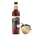DaVinci Gourmet cake batter syrup bottle with serving cup and wooden spoon