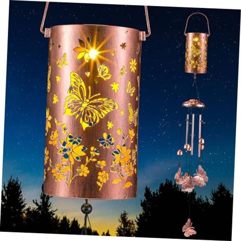 Lit solar butterfly wind chime lantern with copper-pink metal cylinder, butterflies, and chime rods