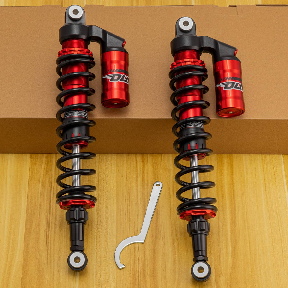 Pair of red-and-black front coil-over shocks with steel springs and mounting hardware