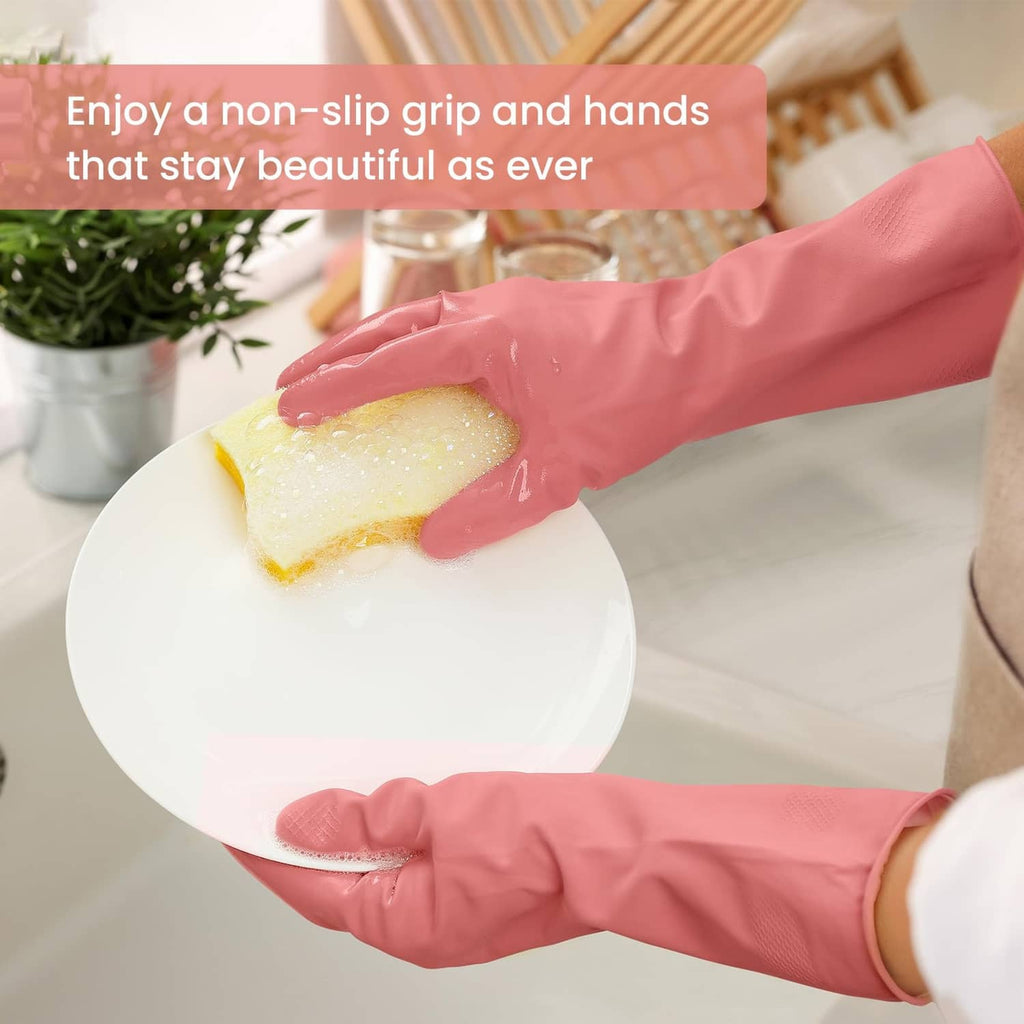 Pink rubber dishwashing gloves with textured non-slip palms, washing a plate