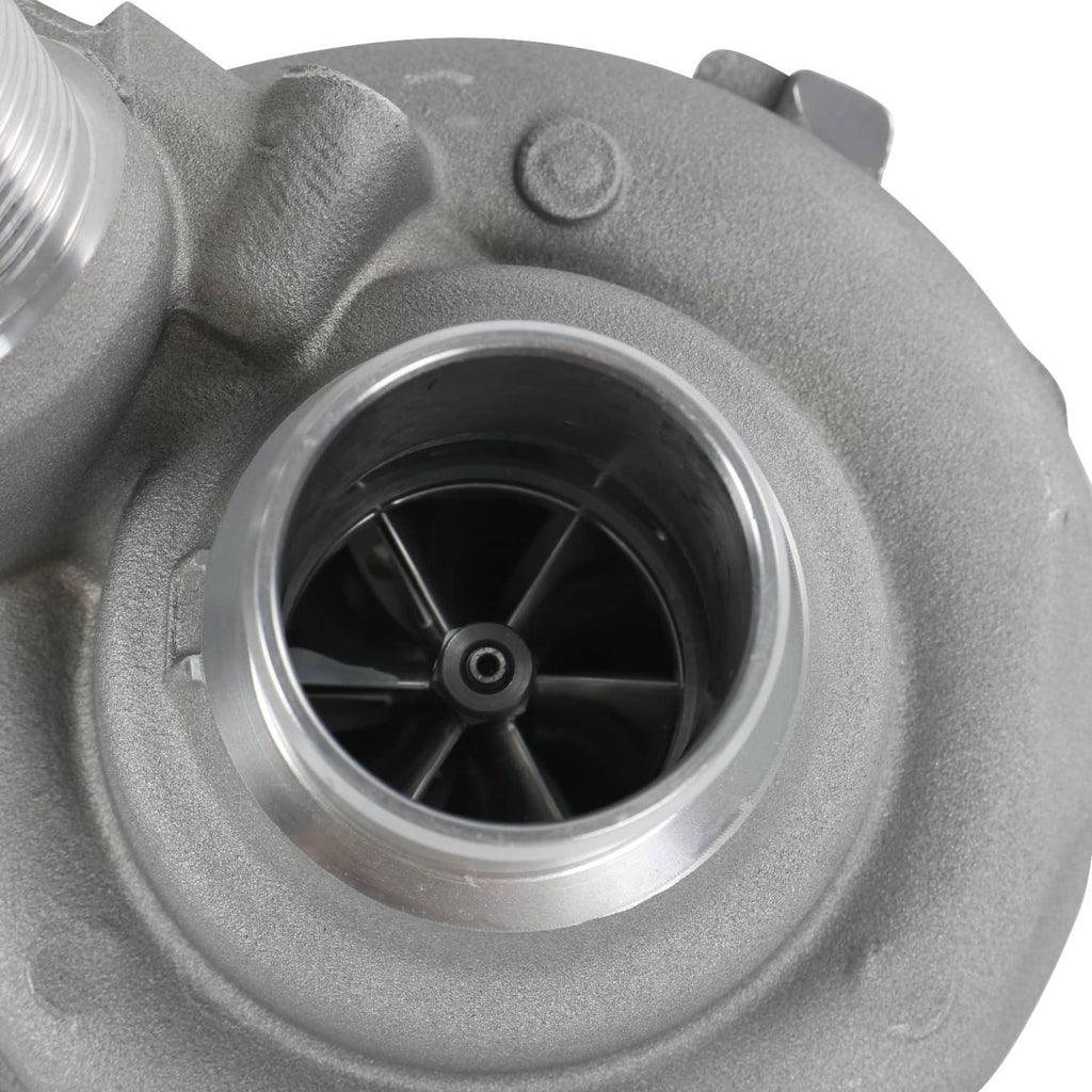 Compressor wheel inside silver inlet housing with visible black blades.