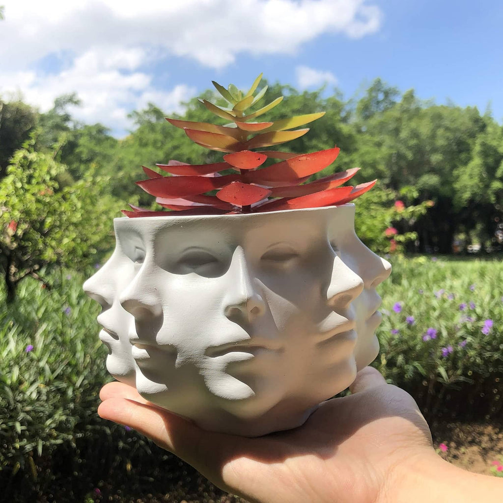 White multi-face succulent planter with stacked red and green faux leaves.