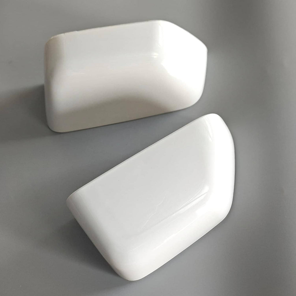 Two white mirror caps with glossy finish and curved outer edges