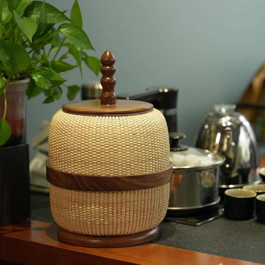 Woven rattan storage basket with dark wooden band, round lid, and turned finial, yellow beige