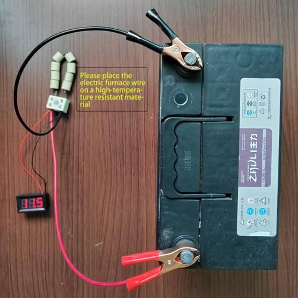 12V battery load tester connected to battery with alligator clips and small voltage display