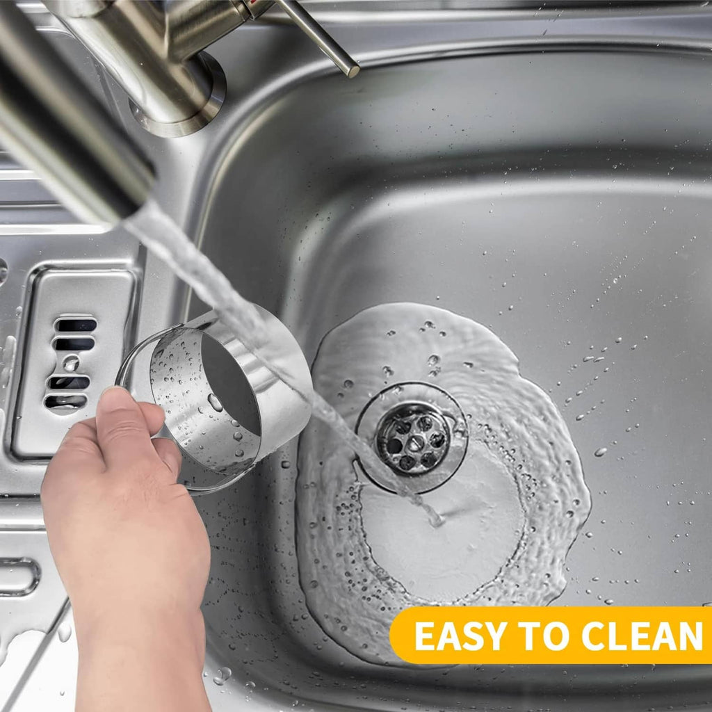 Round stainless steel biscuit cutter being rinsed in a sink
