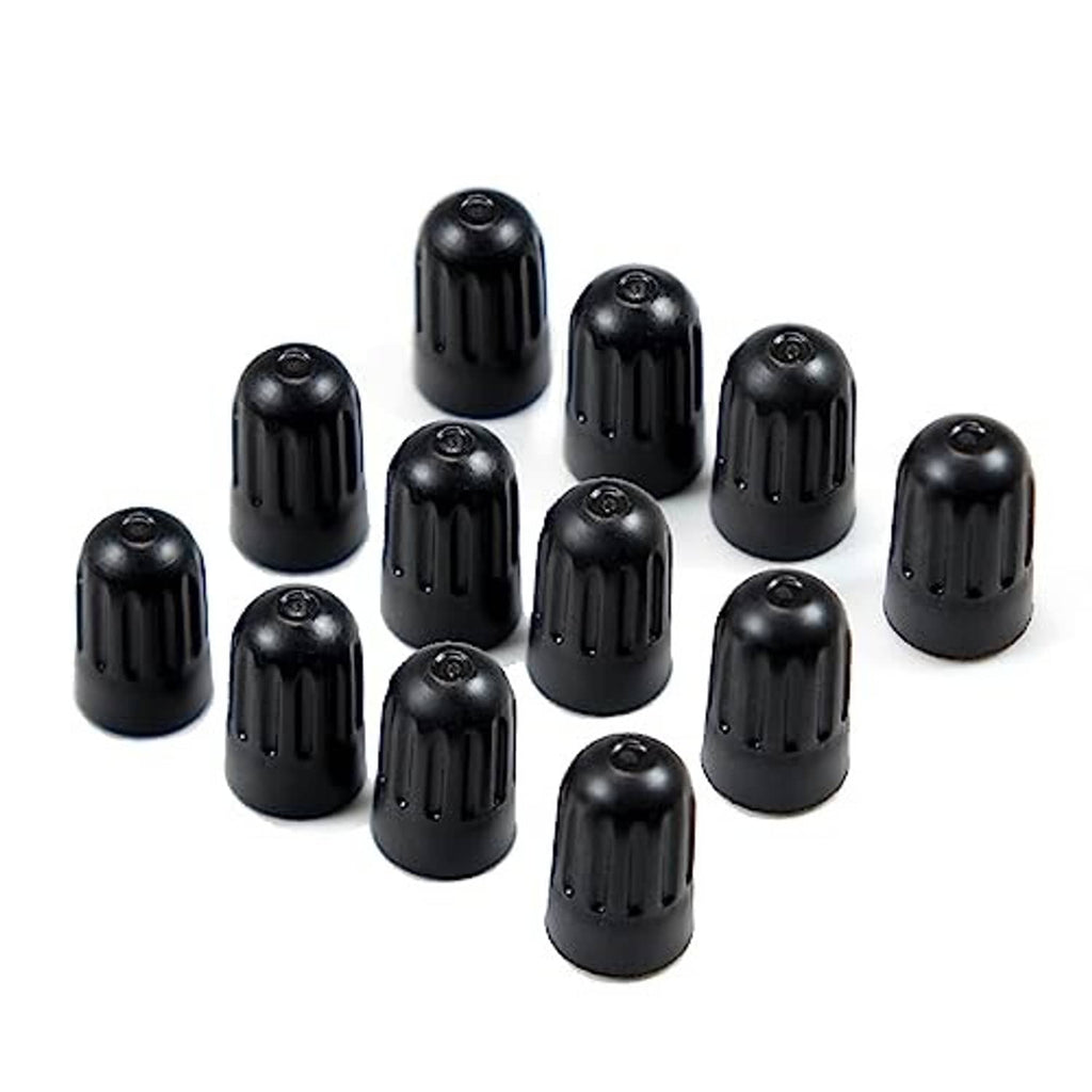 Assorted black long tire valve stem caps, neatly arranged