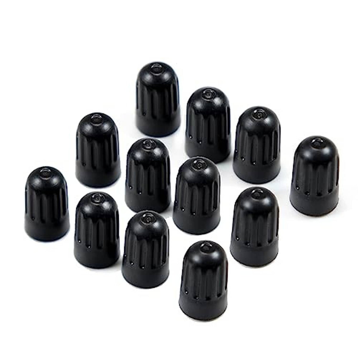 Assorted black long tire valve stem caps, neatly arranged