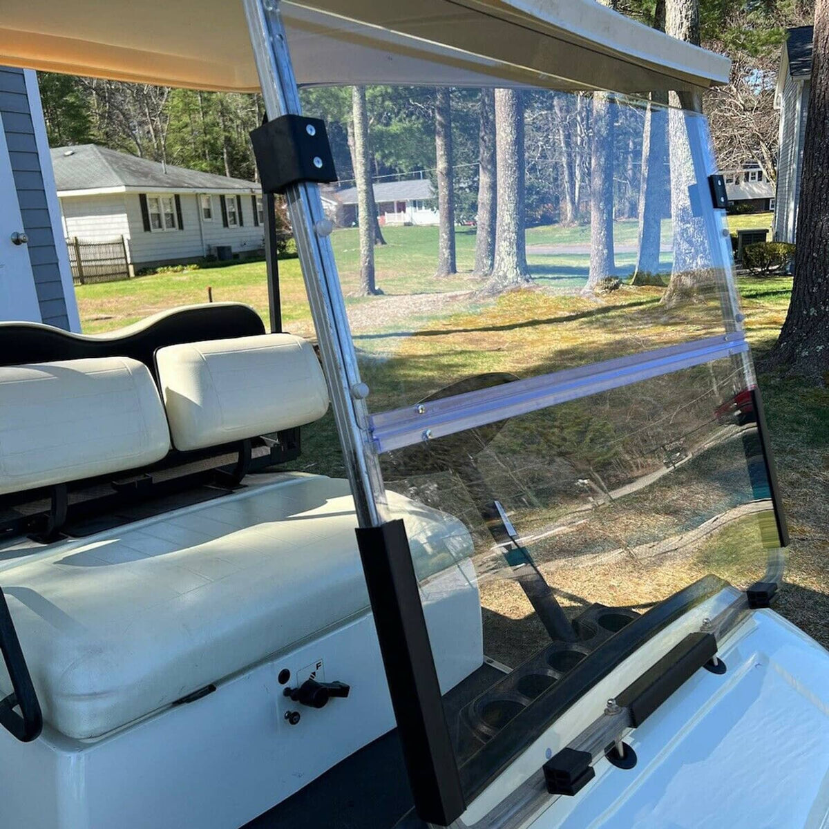 Clear folding windshield with metal support posts and black mounting brackets