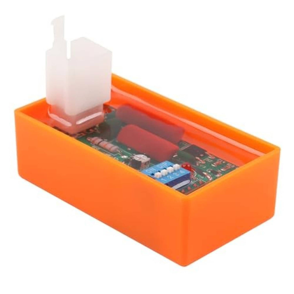 Orange CDI ignition box side view, white connector and DIP switch components