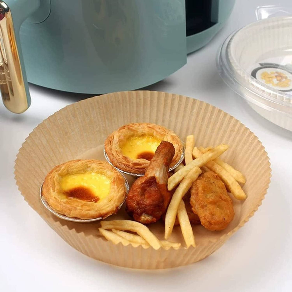 Round paper air fryer liner holding fried food and fries, disposable nonstick