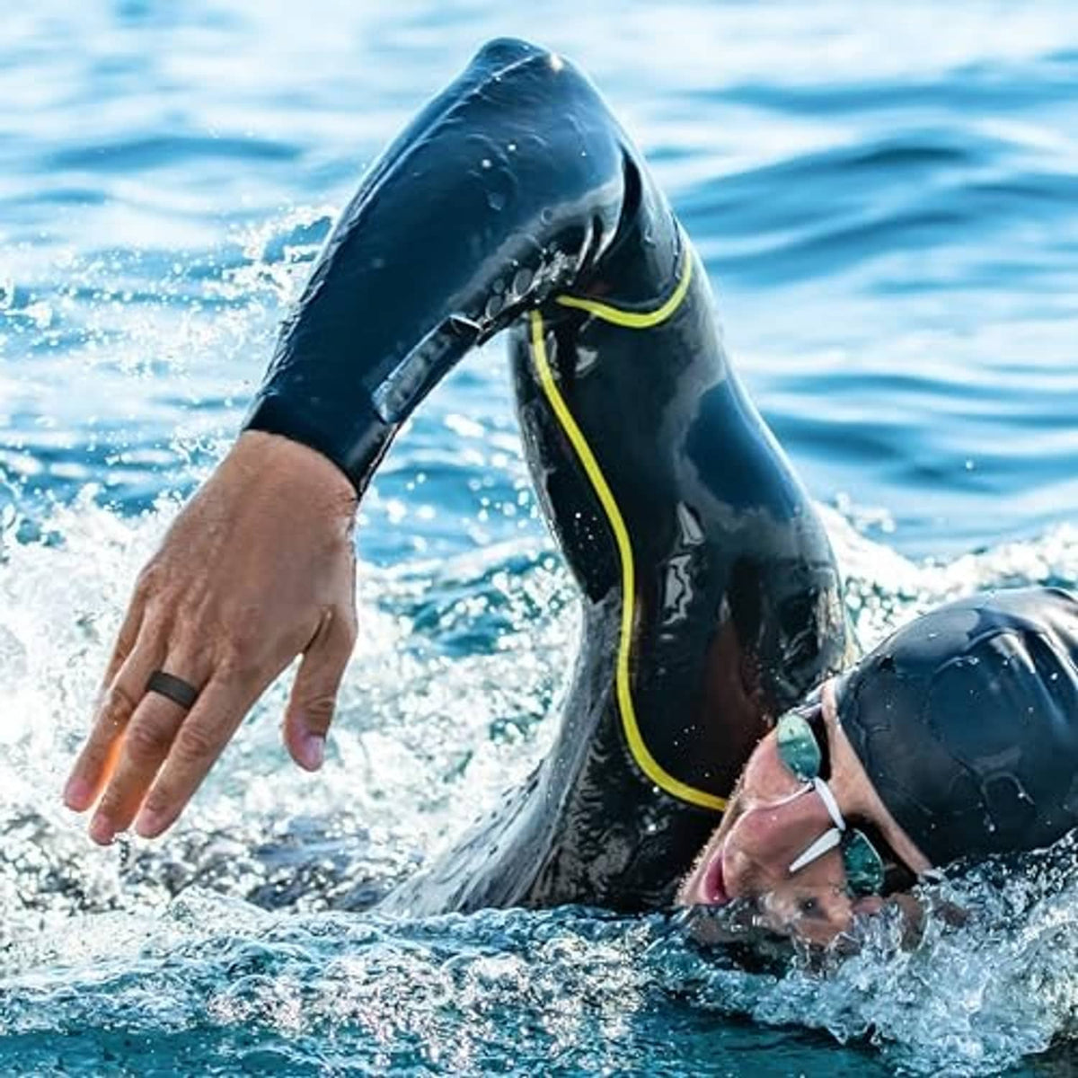 Black ring protector on hand in water, swim-ready snug fit