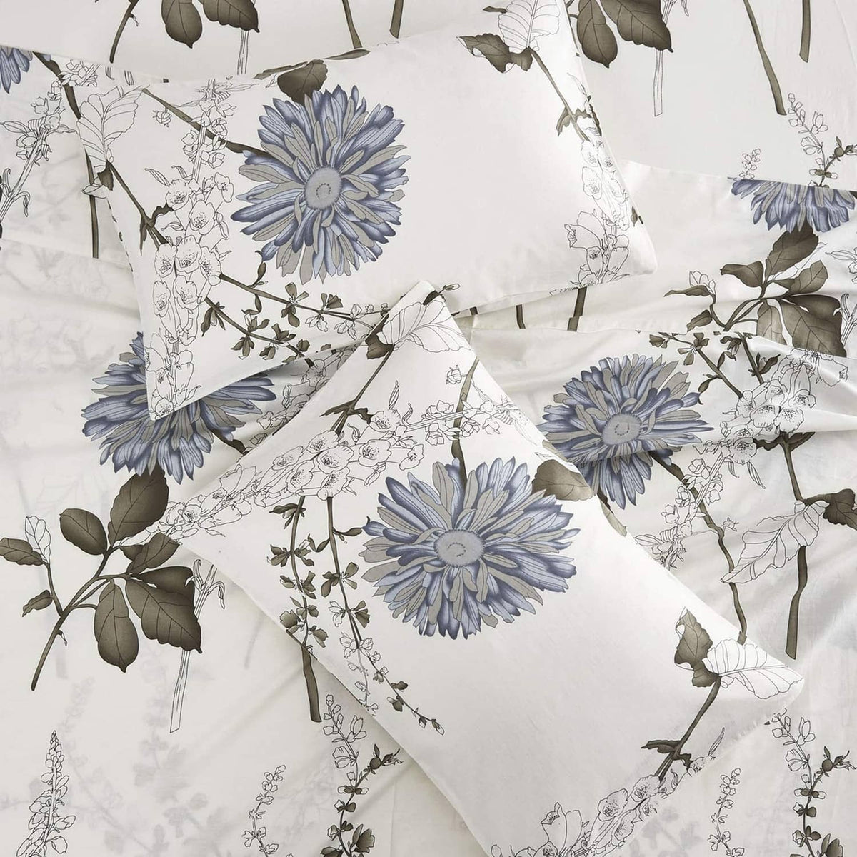 White bed sheet with blue chrysanthemum-style floral print and leafy botanical details
