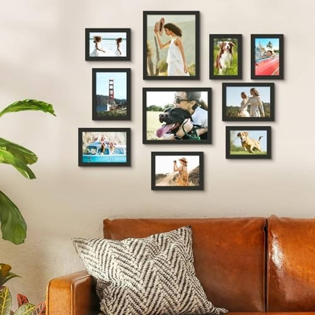 Black picture frame set mounted in a grid on a wall with multiple photos
