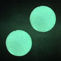 Two mint-green textured glow ball dog toys, round with raised grip pattern.