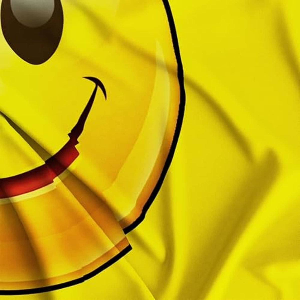 Close-up of yellow smiley face flag print with curved outline and eyes