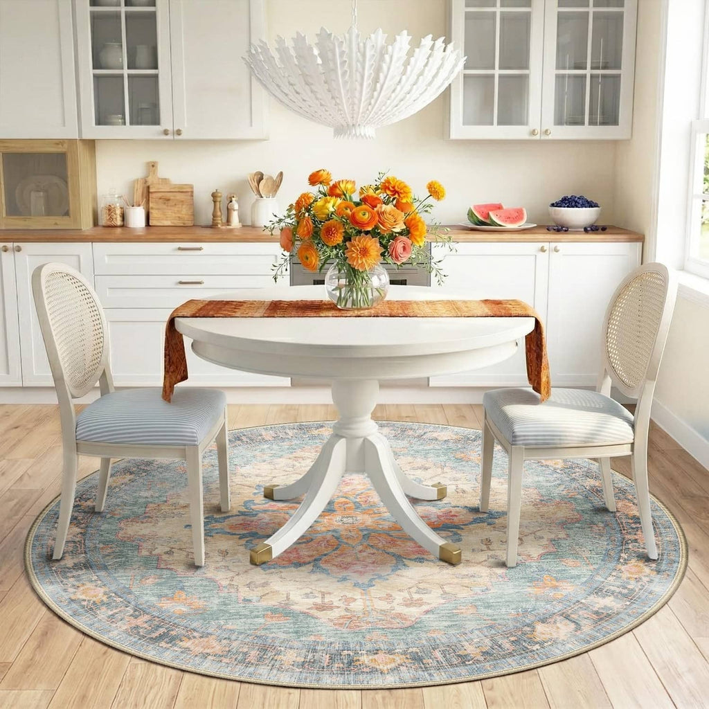 Round washable area rug in blue with ornate orange and red center medallion pattern