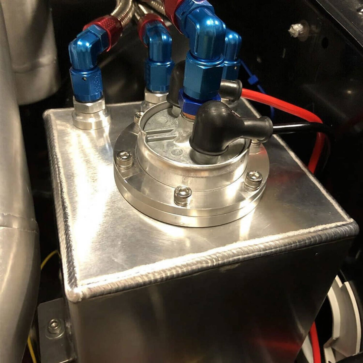 Aluminum fuel surge pot tank top with blue AN fittings and braided fuel lines