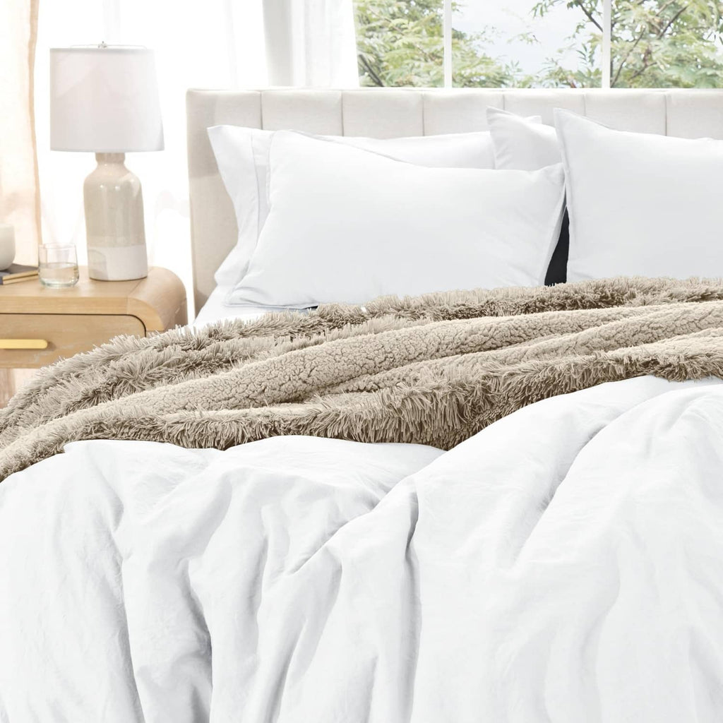 White duvet cover set with pillow shams and white duvet, with gray faux fur throw