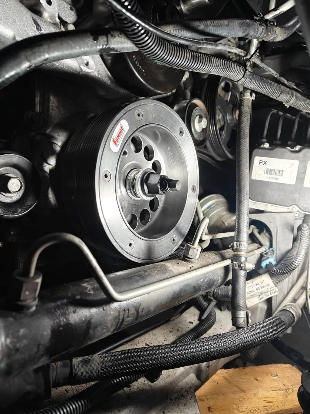 Crank pulley and harmonic balancer installation tool adapter in engine bay