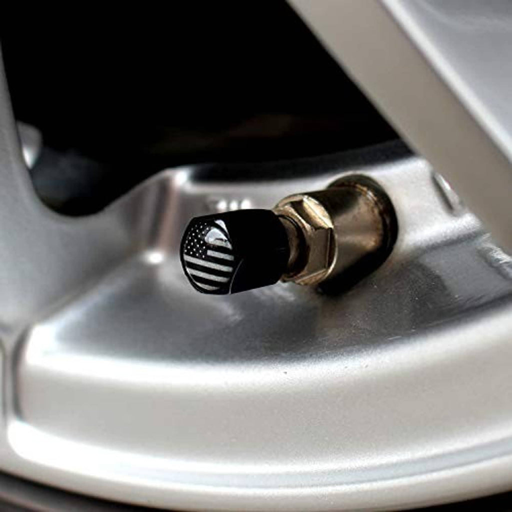 Black American flag valve cap with center opening on silver tire rim
