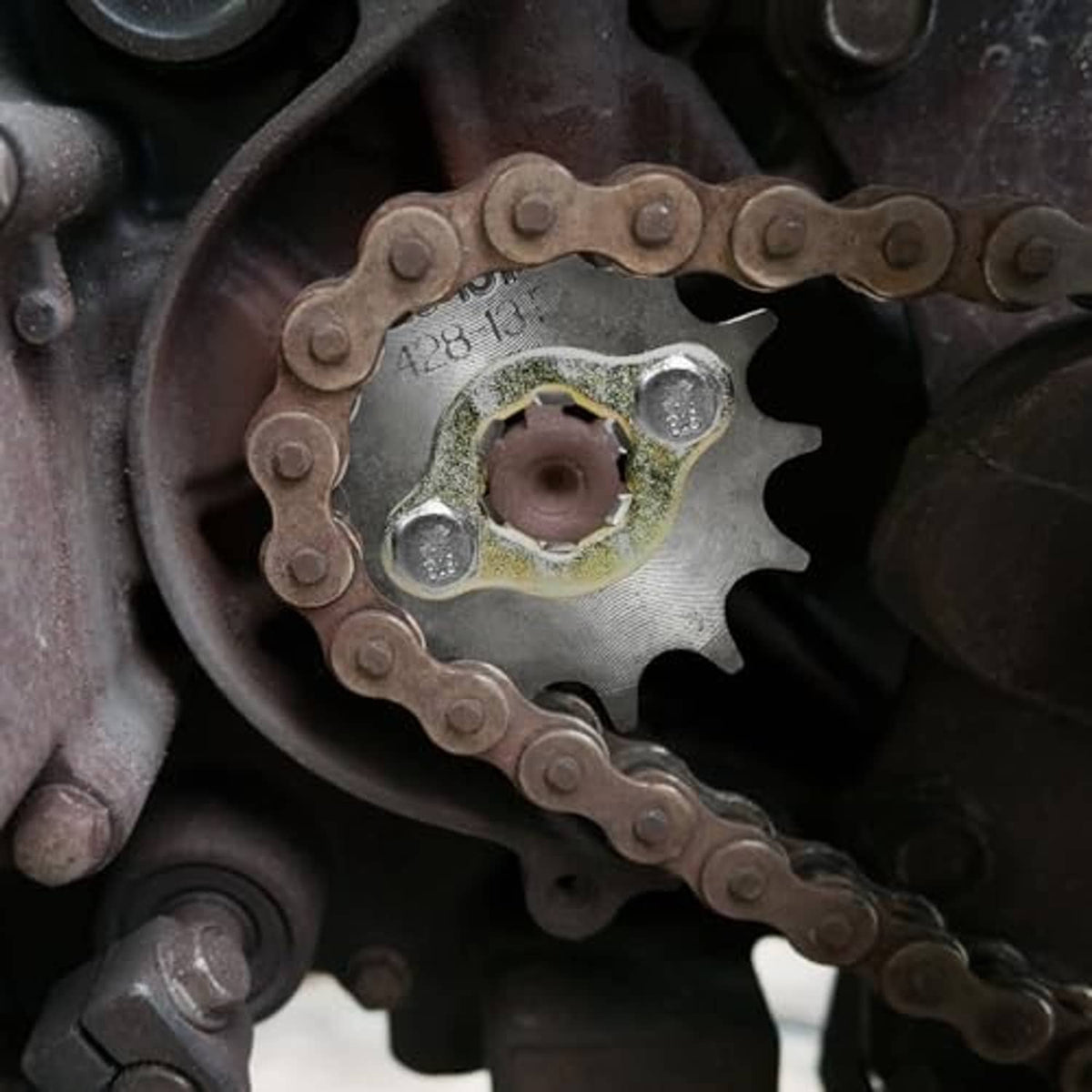 Front engine sprocket kit sprocket with chain wrapped around and mounting hub