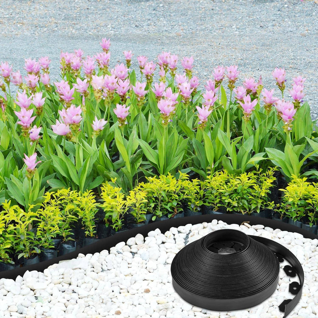 Landscape edging coil placed along a flower bed border with gravel and blooming plants.
