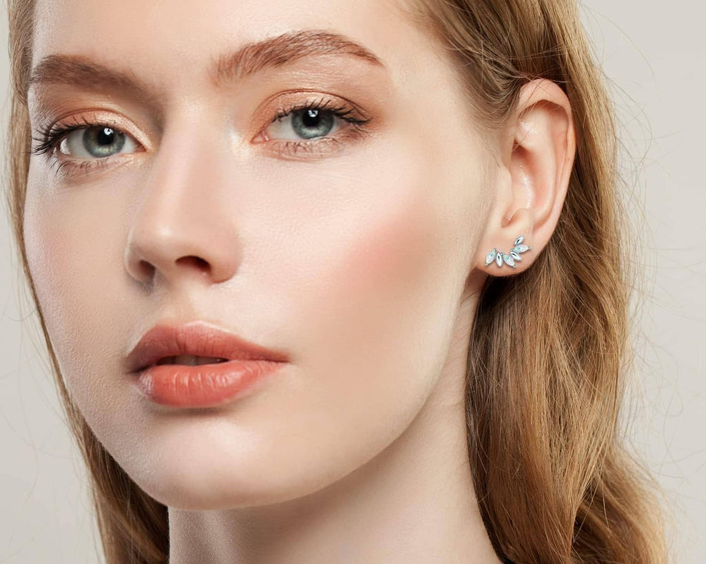 Sterling silver opal stud earrings on model, blue-pink marquise opal stones
