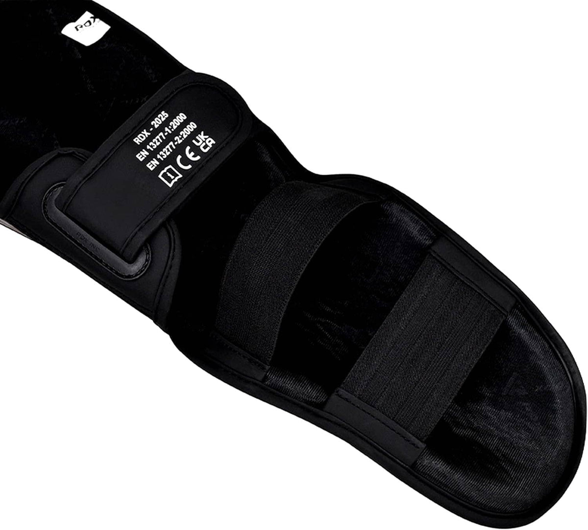 RDX shin instep pad close-up with black elastic strap and product label text