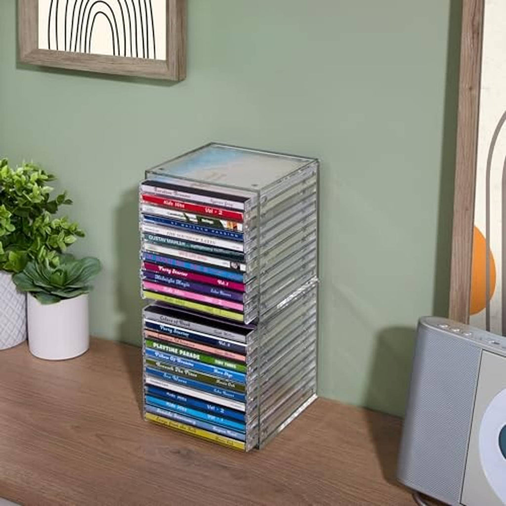 Clear plastic cube CD organizer with stacked jewel cases, compact storage box.