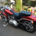 Black one-piece motorcycle passenger seat with diamond-quilted pattern and contoured padding