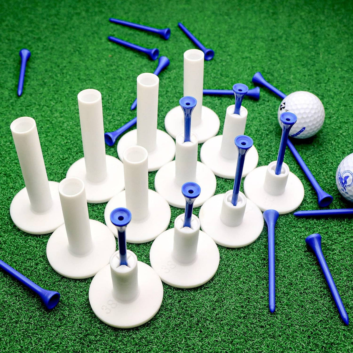 Pile of rubber golf tees with white shafts and blue tips on green turf