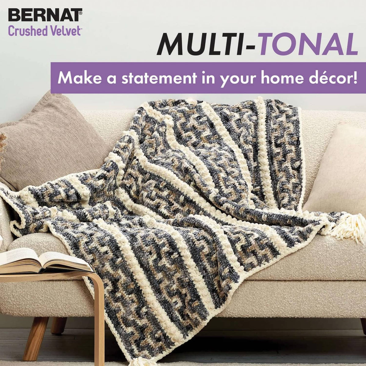 Multicolor knitted throw blanket with bold striped pattern draped over a sofa.
