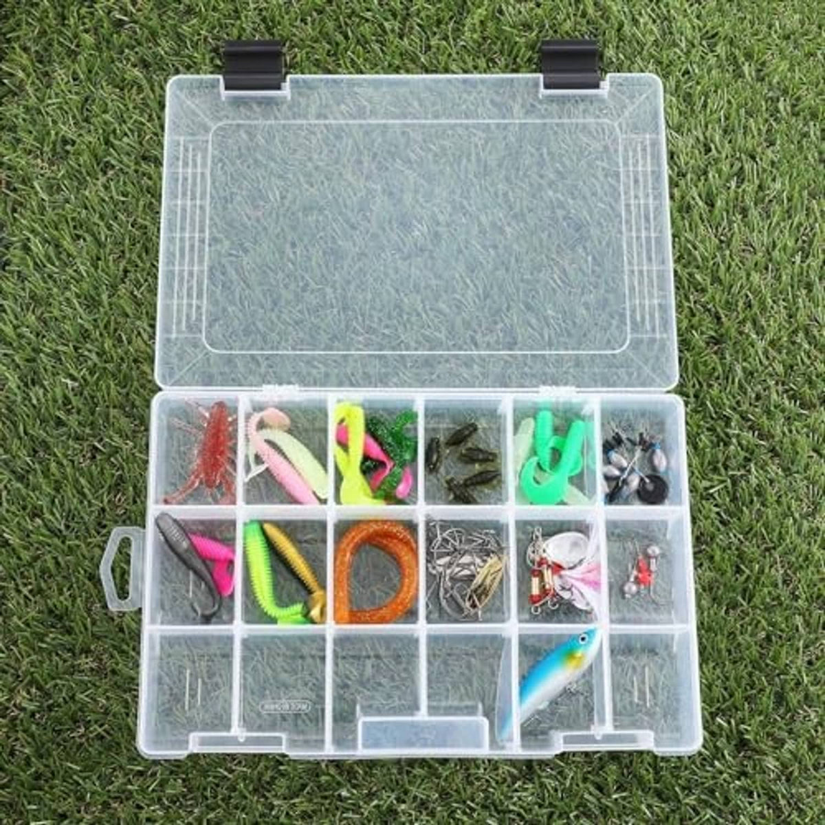 Open clear tackle organizer with removable dividers holding assorted fishing lures