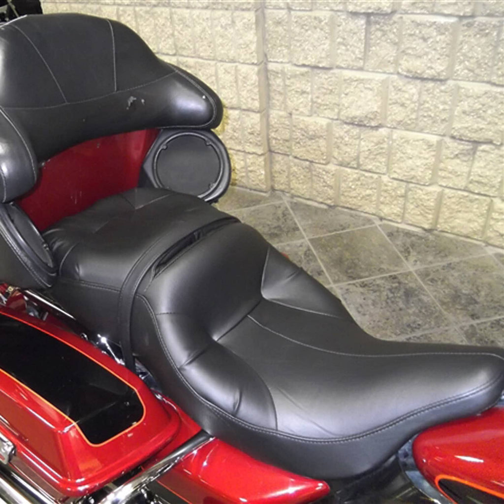 Black motorcycle passenger seat with contoured cushion and stitched seams, side view
