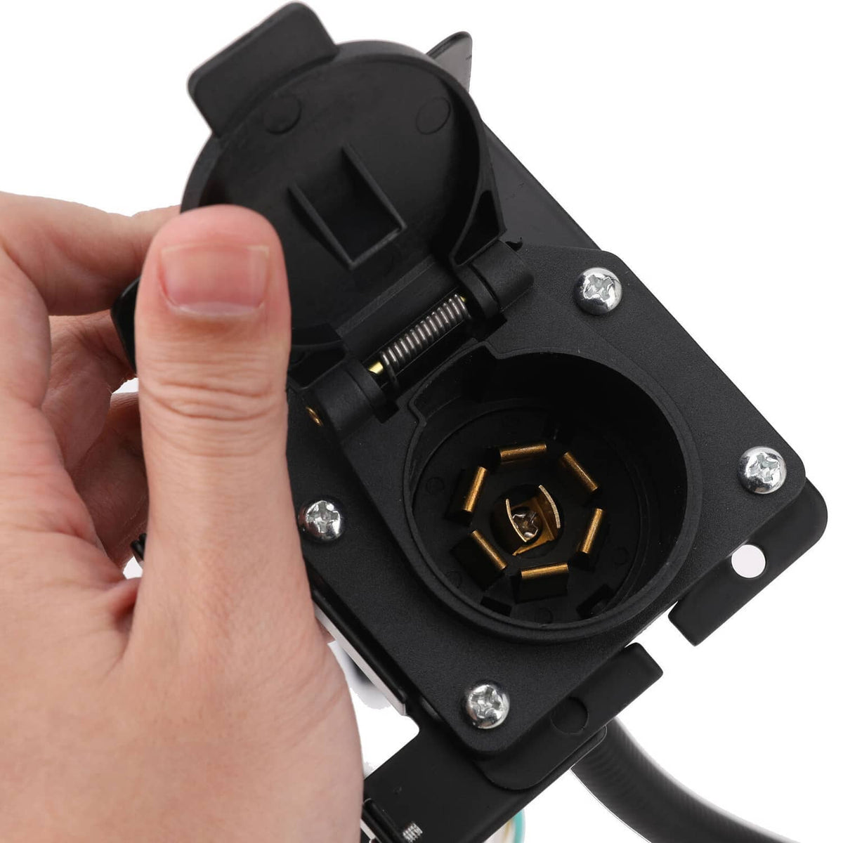 Hand holding black 7-way USCAR plug connector with circular socket and mounting screws
