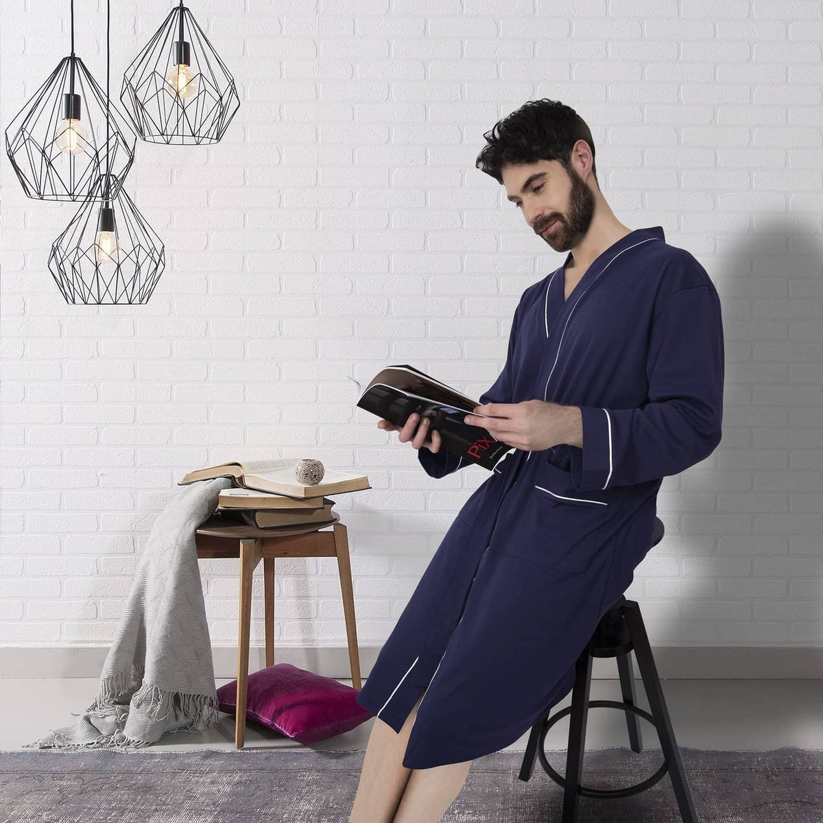 Men’s navy bathrobe with belt tie, front view while standing indoors.