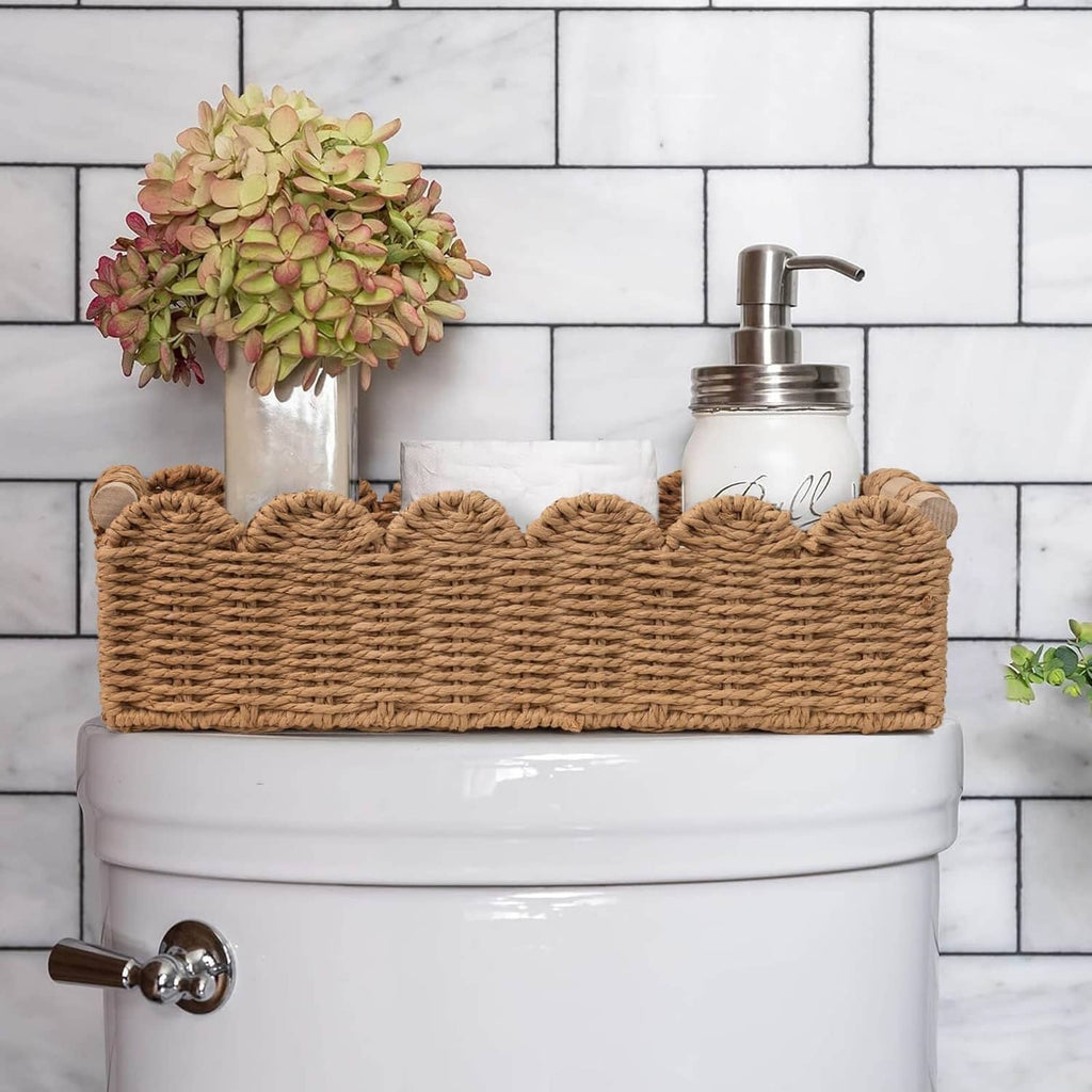 Scalloped woven rattan toilet paper basket with tissue roll and pump soap
