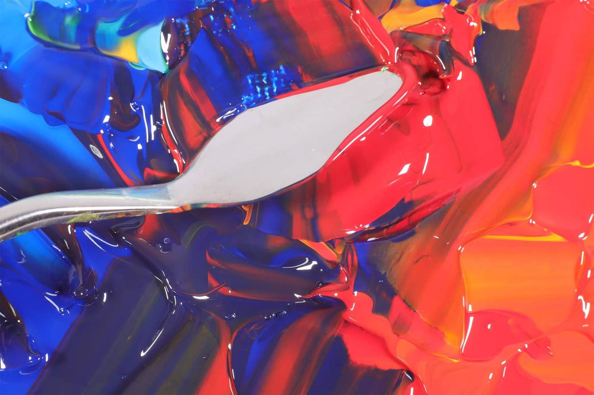Thick acrylic paint swatches in red, blue, and white with glossy, textured surface