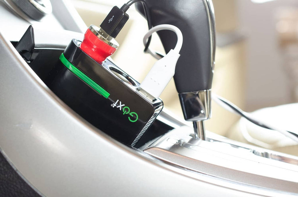 Goxt 12V dual USB car socket plugged in near center console, black with green accents