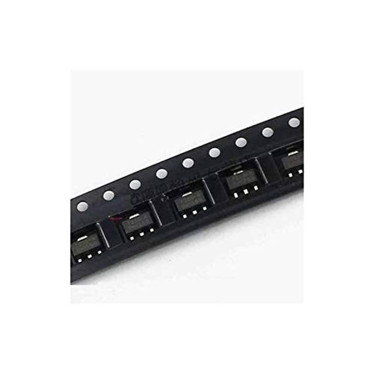 SOT-89 LDO voltage regulator ICs, black surface-mount chips on strip with pins